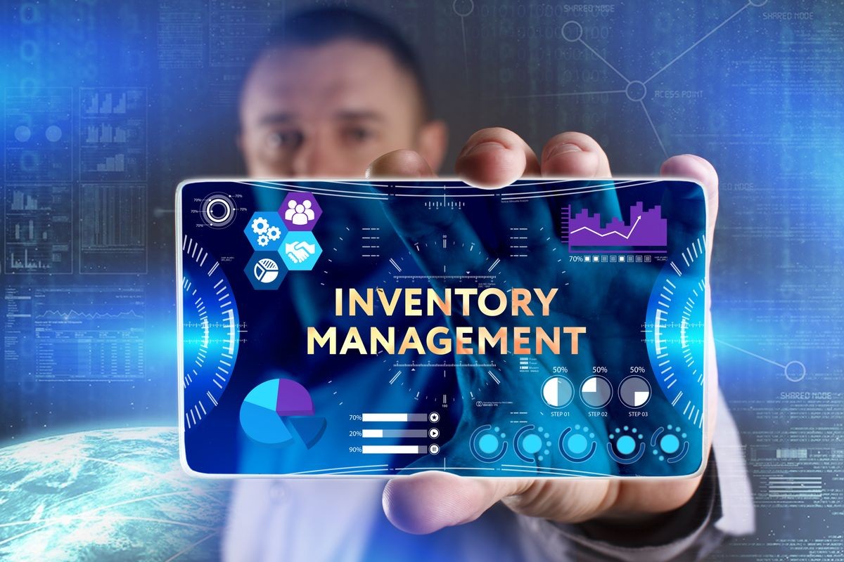 Business, Technology, Internet and network concept. Young businessman showing a word in a virtual tablet of the future: Inventory management